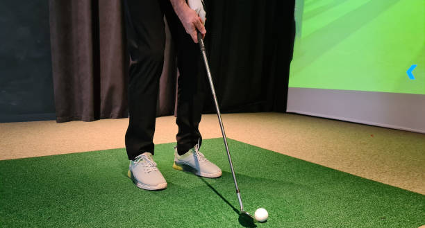 istock Golf player playing golf indoors on golf simulator closeup 1809614792