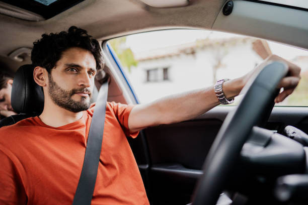 istock Mid adult man driving car 1809631171