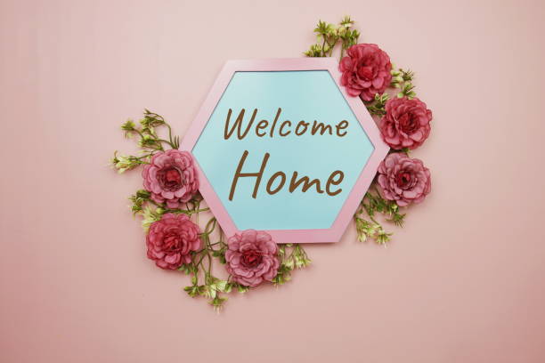 Welcome Home typography text decorate with flower on pink background