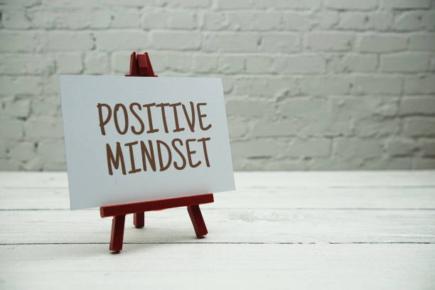 istock Positive Mindset text on white brick wall and wooden background 1809638342