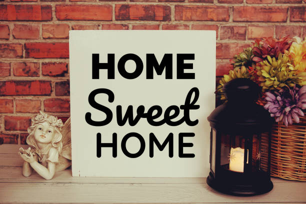 istock Home Sweet Home text message with flower and lantern decoration on brick wall background 1809643523