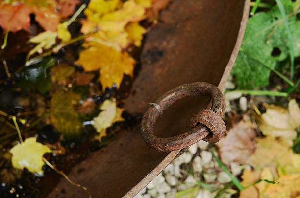 Vintage metal tub with yellow maple leaves - fall outdoor decor,  selective focus on tub handle