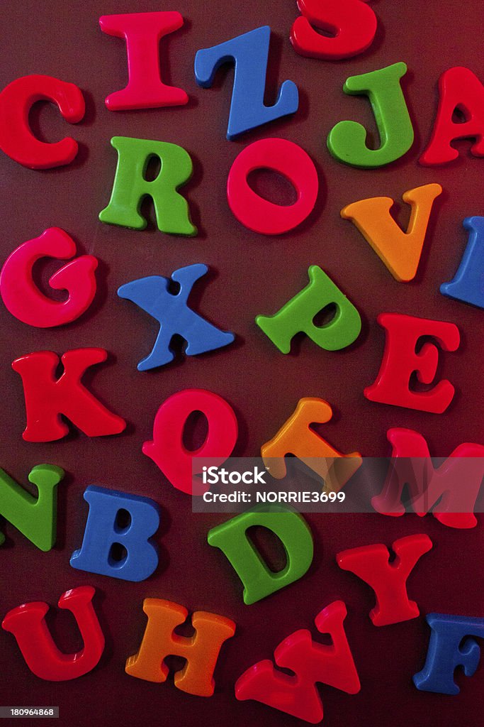 Magnetic Letters A variation of magnetic letters of all bright colours stuck to a fridge side. Letter L Stock Photo