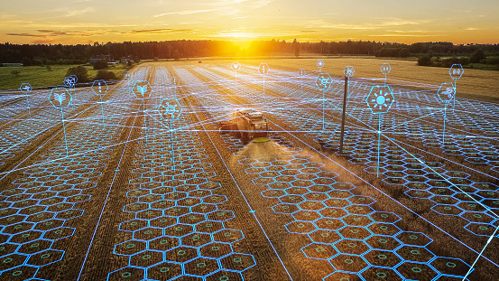 Aerial Shot: Harvester Working on Field. Digitalization of the Crops Growing Efficiency with AI Data Analysis. Futuristic Agriculture Concept of Computerized, Eco, Sustainable Harvesting Solution.