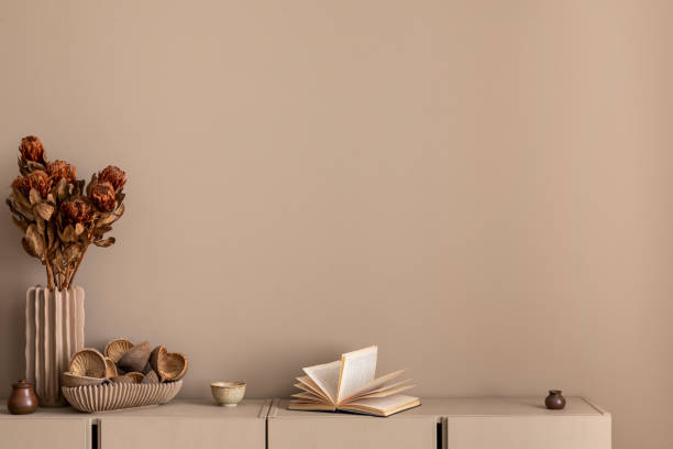 istock Minimalist composition of living room interior with copy space, simple beige sideboard, vase with dried flowers, books and personal accessories. Home decor. Template. 1809662920