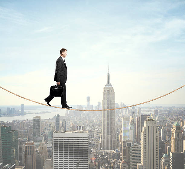 istock A man walking on a rope over a city 180966951