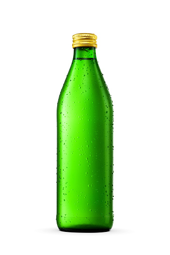 Mineral water in green glass bottle with water condensation and ice crystals isolated on white background.