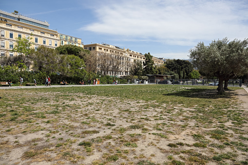 Nice, France - April 28, 2023: The Promenade du Paillon has a large lawn, which now needs to be maintained. The city buildings can be seen a little further away.