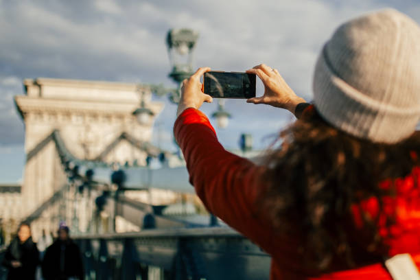 istock Woman walking on Chain bridge in Budapest, taking photos 1809689291