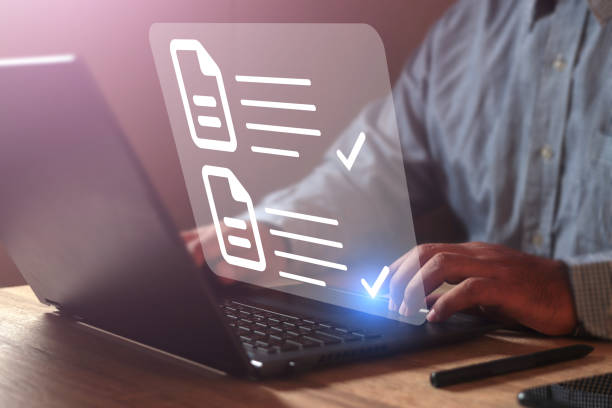 istock Businessman using laptop computer tick correct sign mark in online document checklist for quality control assurance of ISO concept. 1809690883