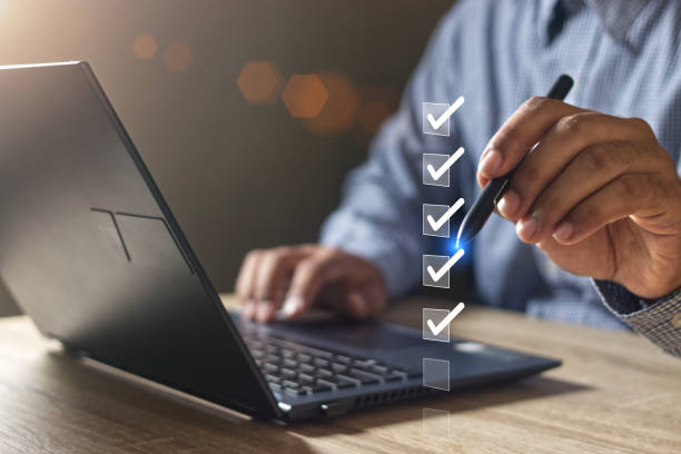 istock Businessman use pen to tick correct sign mark in checkbox for quality document control checklist and business approve project concept. 1809690887
