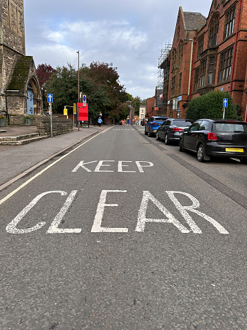 Keep clear sign painted on car road