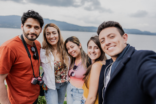 Traveler friends taking a selfie outdoors - camera point of view