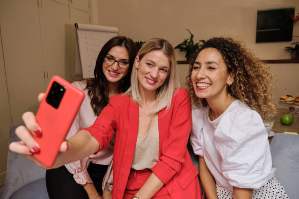 istock Smiling women taking selfie together on smartphone 1809722177