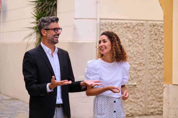 istock Cheerful colleagues talking on street 1809724402