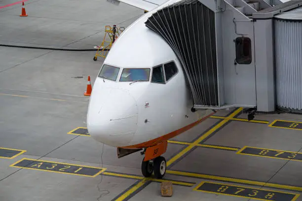 Close-up photo of a Ukrainian airline SkyUp Airlines' Boeing 737-800 standing at the gate with airbridge connected in Lviv