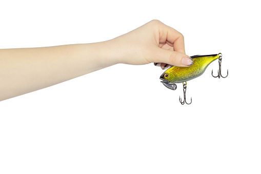 fishing bait in outstretched hand isolated from background