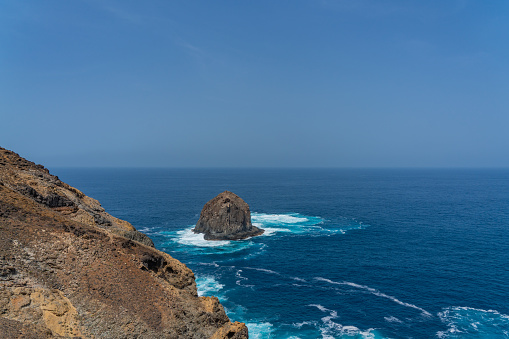 Steep cliffs with rocky peaks, coastal landscapes with a rocky island of Santo Antao Island, Cape Verde.