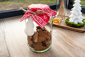 Baked gingerbread in various shapes without decorations in a closed jar.