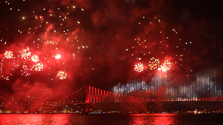 Fireworks over the Istanbul City. View of Ortakoy region and Bosporus Bridge. Pan from Ciragan Palace to the bridge.