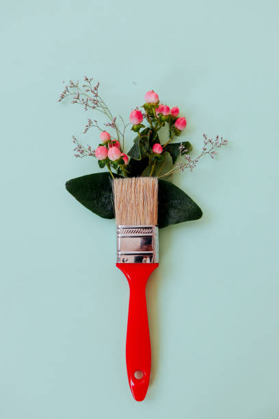 istock Flower composition. Creative layout of flowers and brushes on a light green background. 1809764738