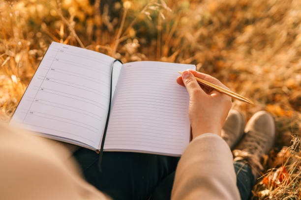istock Girl with paper planner outdoors, autumn concept 1809771744