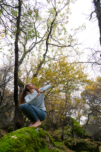 Woman doing yoga in a forest