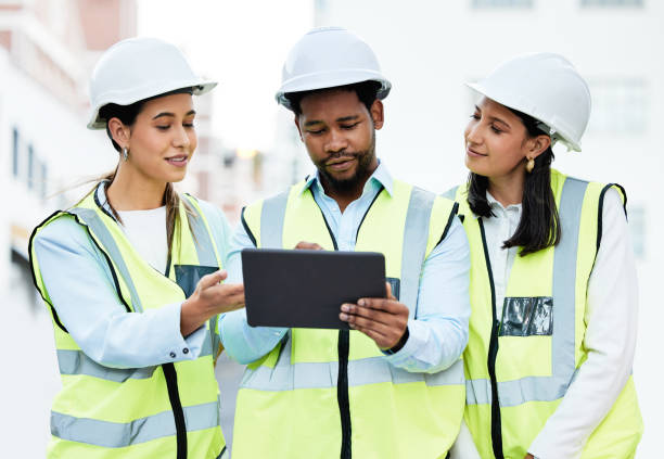 istock Building, digital tablet and construction worker team collaboration and planning at a site, checking online plan and strategy. Vision, design and engineer group discuss project details for innovation 1809797027