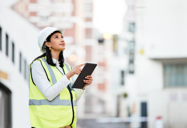 istock Woman, building manager and construction on tablet doing inspection and working on site in the city. Female architect or builder contractor checking architecture at work on touchscreen technology 1809797566
