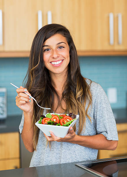 istock Healthy woman eating salad 180980573