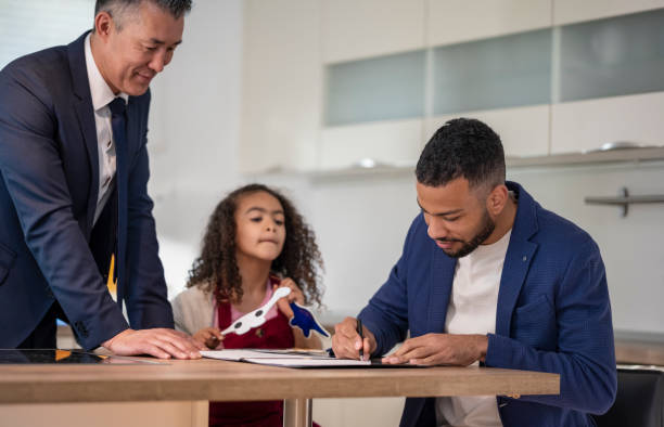 istock Father With Daughter Signing House Ownership Agreement 1809809236