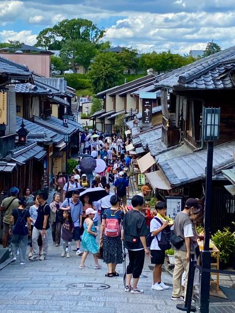Japan - Kyoto - Ninenzaka street - famous tourist streetIn this photo we can notice that this famous tourist street in Kyoto is crowded with tourists walking around and taking photos.
