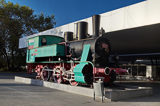 Sofia, Bulgaria -  November 07, 2023: View of a pleasant corner of the Central Railway Station with an old steam locomotive on display, Sofia, Bulgaria. Visit in place.