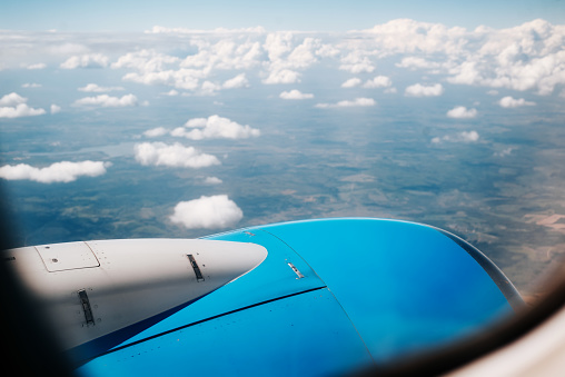 Looking out the window of a flying airplane, inside