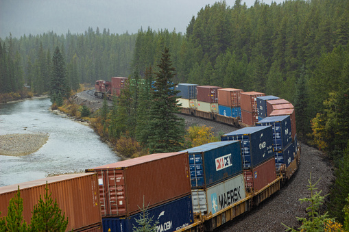 A Canadian National Railway loaded with carriages around the famous curve in the Rocky Mountains of Canada