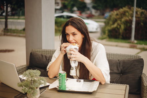Woman eating during her working day stock photo