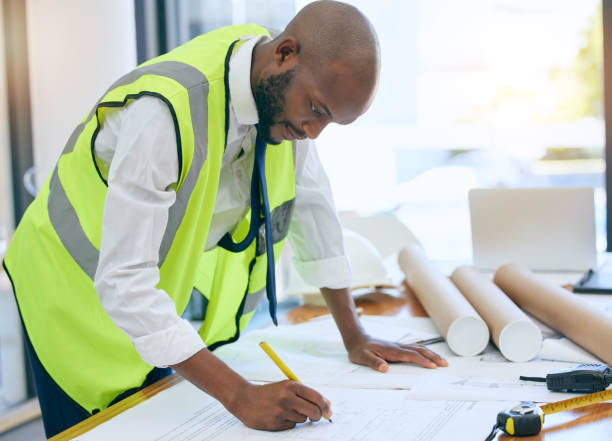 istock Architect, blueprint and man writing in office on paper, design and planning building project. Construction, engineer and male project manager with plan for property, model or renovation strategy 1809859801