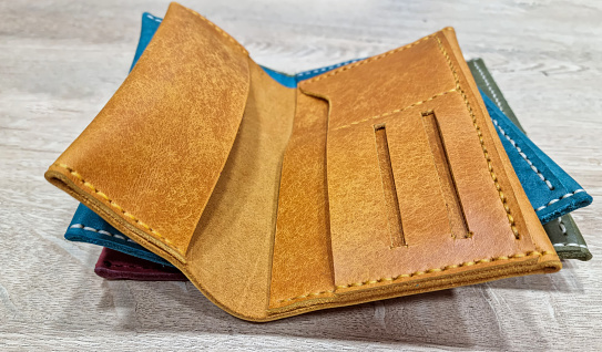Red walletMulticolor wallet on wooden