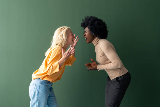istock Two young women of different ethnicity screaming face to face 1809883183