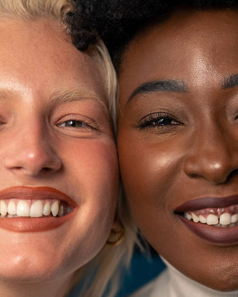istock Cheerful young women with different skin tones smiling at camera while standing together 1809885415