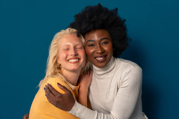 istock Young women of different ethnicity smiling happily while standing together 1809885432