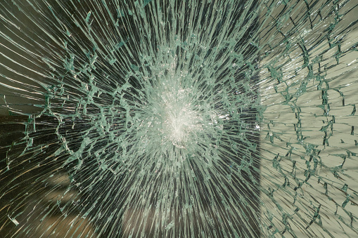 A security glass of a store fractured by a strong impact without breaking. High hardness safety glass. Real photography. Horizontal photo.