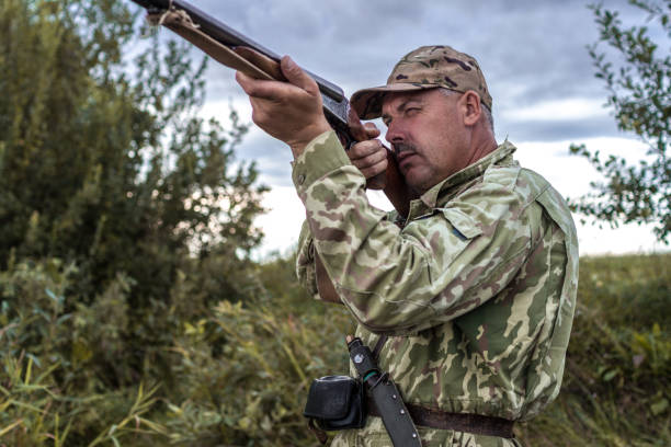 istock Hunter in uniform with a hunting rifle. Hunting Concept 1809918518