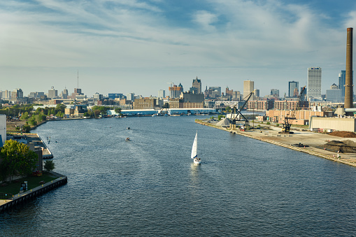 Aerial shot of sailboat sailing on Kinnickinnic River on a mostly clear day in Fall.