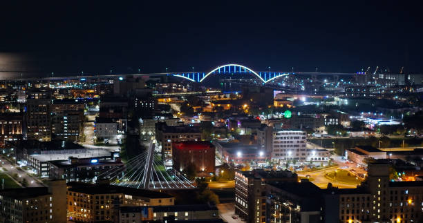 aerial view across milwaukee towards illuminated hoan bridge at night - interstate 94 стоковые фото и изображения