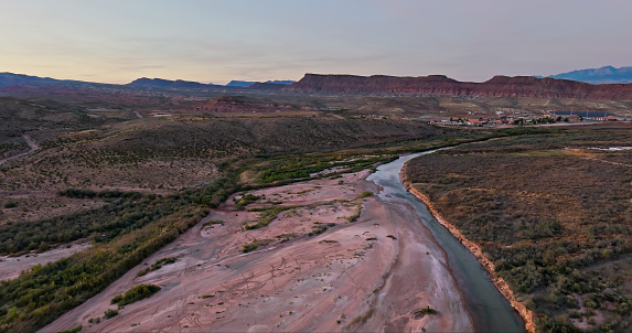 Drone shot of Virgin River flowing through desert landscape on the edge of St. George, a city in Washington County in southwestern Utah.