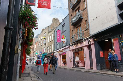 DUBLIN, Ireland - August 4, 2023: City life along a street in Temple Bay quarter, famous tourist destination known for its cultural institutions and for nightlife