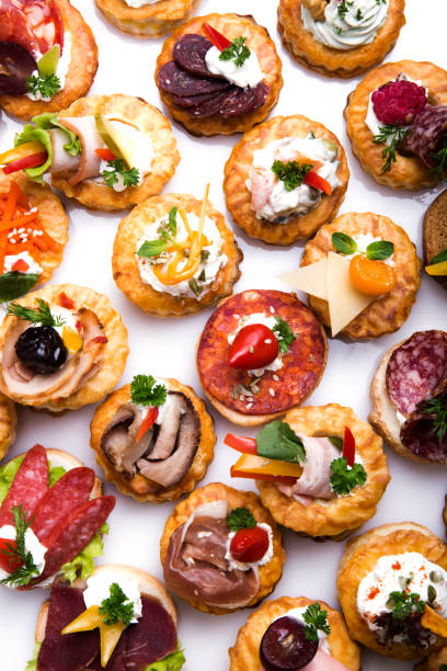 different canapes with smoked salmon, cucumber cherry tomatoes and mozzarella - tablesetting imagens e fotografias de stock