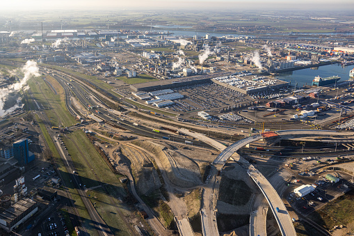Aerial view Dutch industrial area Rotterdam with construction site new Freeway cloverleaf