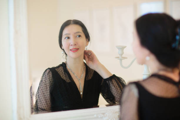istock Young Asian woman looking in the mirror. 1809941329
